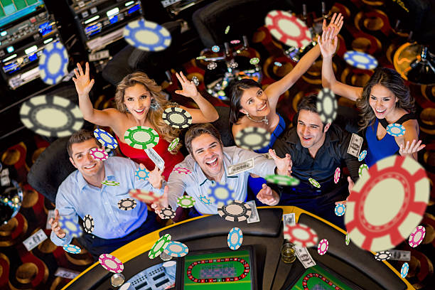 Happy group of people winning at the casino